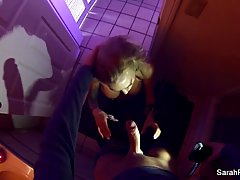 Sarah Jessie is kneeling in front of her partner and gently sucking his huge cock