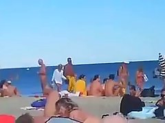 Many kinky couples are having sex on the beach and enjoying while others are watching them