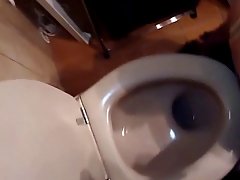 Naughty brunette is kneeling on the floor, in front of her partner and sucking his hard cock